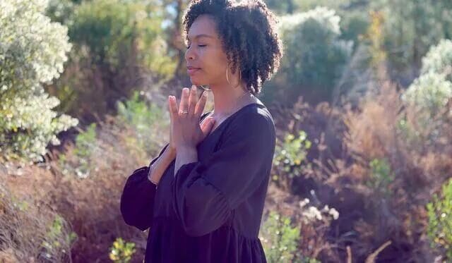 A believer sitting peacefully in prayer, reflecting on why is God silent