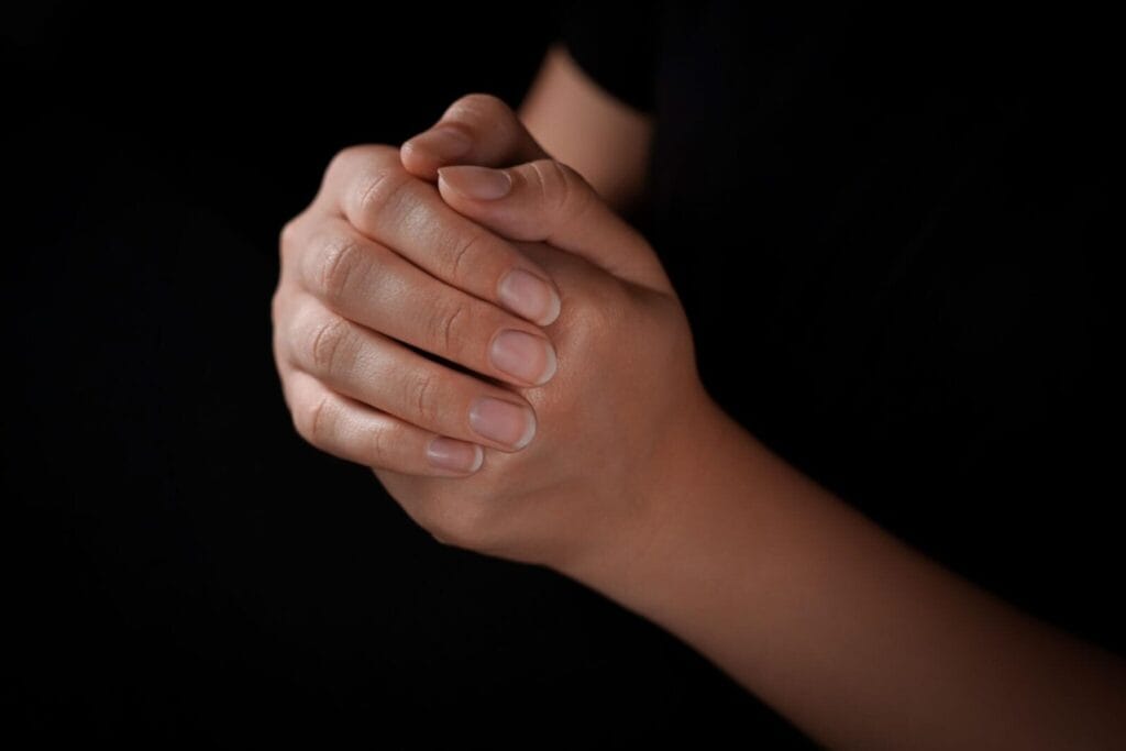 A believer sitting peacefully in prayer, reflecting on why is God silent
